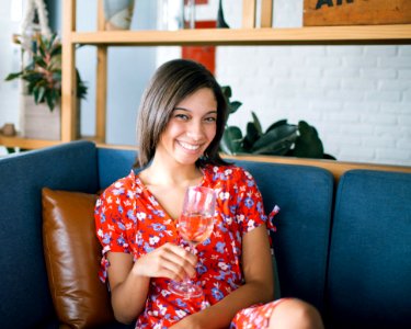 Woman Holding Wine Glass Sitting In Sofa
