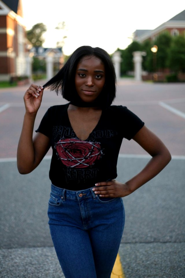 Woman In Black Top And Blue Jeans