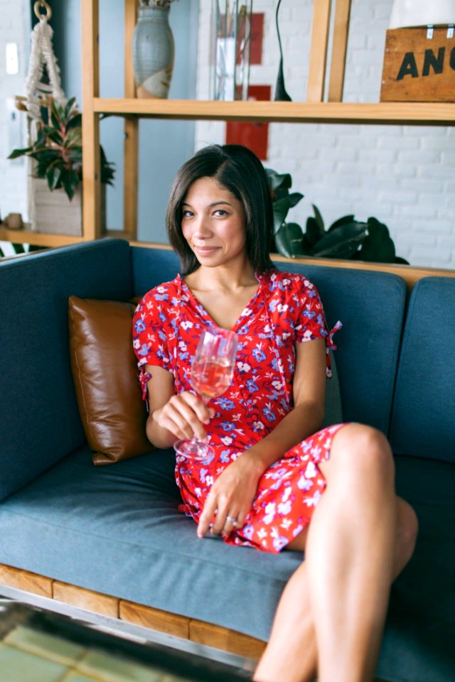 Woman Sitting On Sofa Holding Wine Glass