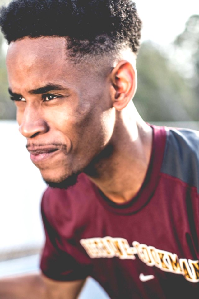 Man Wearing Maroon And Grey Crew-neck T-shirt photo