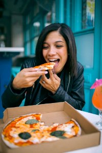 Photo Of Woman Eating Pizza photo