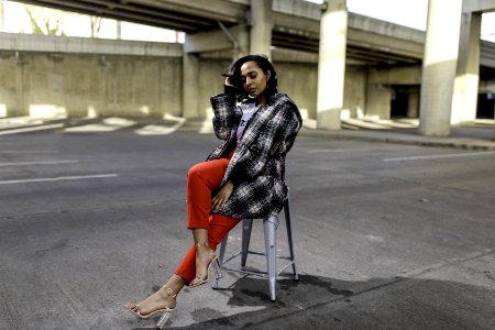 Photo Of Woman Sitting In The Middle Of The Road photo