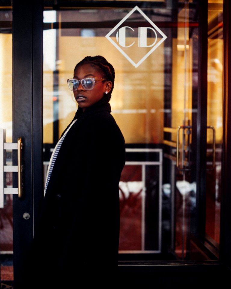Woman Wearing Black Coat And Sunglasses