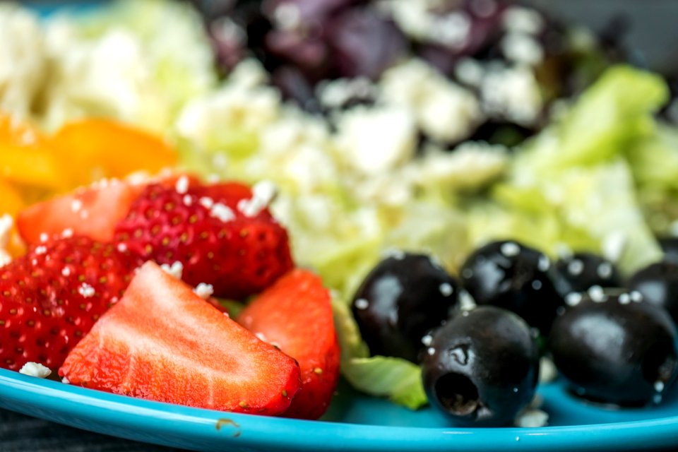 Shallow Focus Photography Of Sliced Strawberries And Black Olives