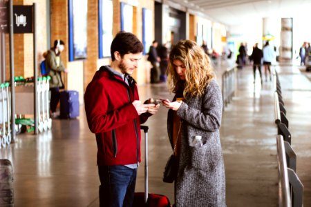Photo Of Man And Woman Using Their Phones photo
