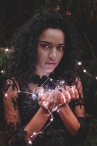 Woman In Black Lace Dress Holding String Lights photo