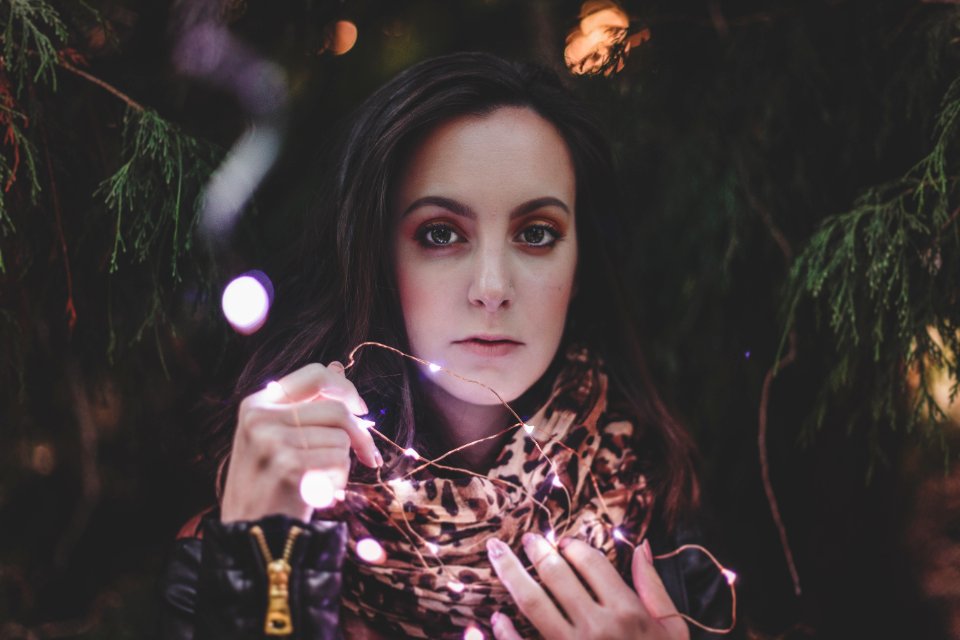 Woman Holding White String Lights