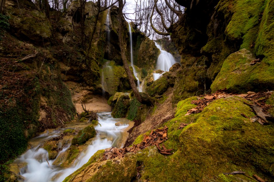 Long Exposure Photo Of Stream Falling In Between Rocky Mountain photo