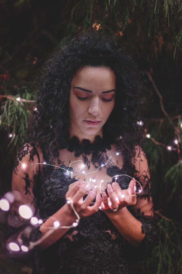 Woman Wearing Black Floral Dress Holding Fairy Light