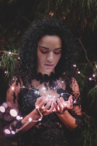Woman Wearing Black Floral Dress Holding Fairy Light photo