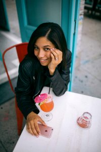 Woman Sitting On Chair With Her Hands Below Her Cheek