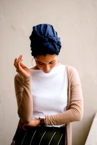 Woman Wearing Blue Turban White Top And Brown Cardigan photo