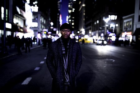 Man Wearing Gray Coat Standing In The Middle Of The Road photo