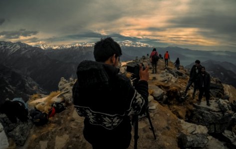 Man Taking Photo Of Couple On Mountain Range photo