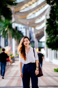 Woman Wearing White Dress Shirt And Blue Pants