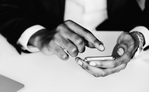 Monochrome Photography Of A Person Using Mobile Phone photo