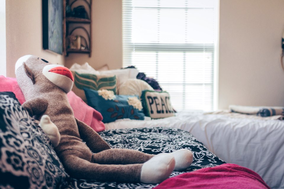 Sock Monkey Plush Toy On Bed photo