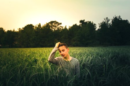 Man Wearing Gray Sweatshirt Standing On Grass Field photo