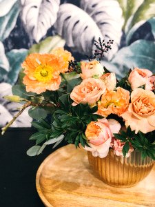 Peach Peony Flowers And Pink Poppy Flowers In Vase On Table Centerpiece photo