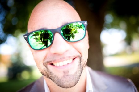 Shallow Focus Photography Of Man In Gray Top Wearing Green Sunglasses With Black Frames photo