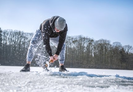 Person Holding Shovel On Snow Field photo