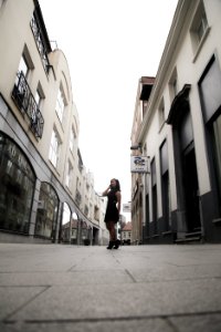 Woman Wearing Black Sleeveless Dress In Between Buildings photo