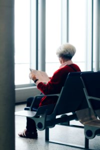 Person In Red Coat Sitting On Chair