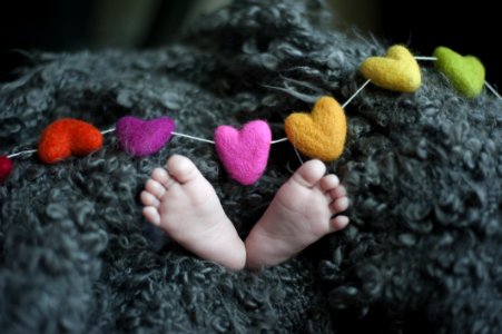Babys Feet Covered With Black Wool Textile