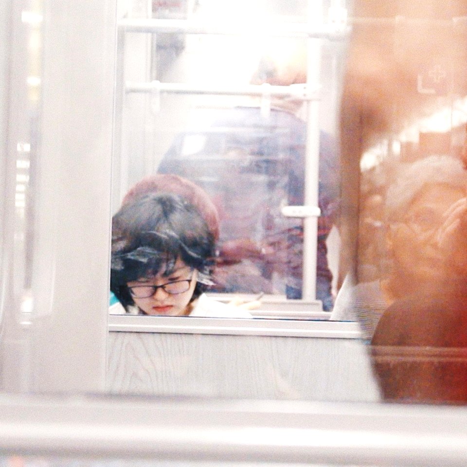 Woman Wearing Eyeglasses Reflection On Mirror