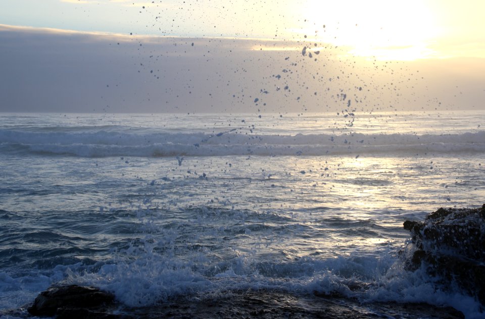 Ocean Waves Hammering Rock Boulder