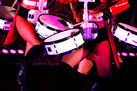 Group Of Women Playing White And Black Drums photo