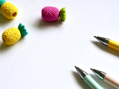 Closeup Photo Of Three Assorted-color Pens Near Pineapples Miniatures photo