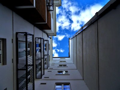 Low-angle Photography Of Gray Concrete Building Under Blue Sky At Daytime photo