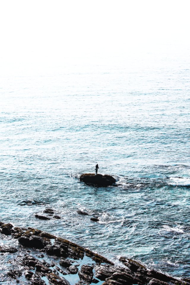 Person Standing On Rock Formation