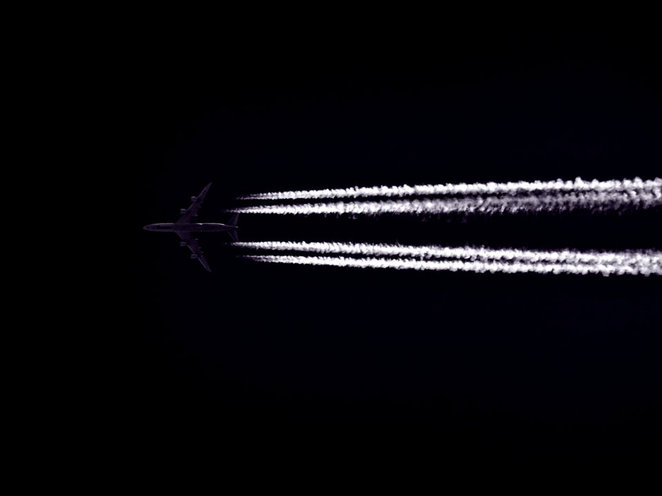 Photo Of Airplane Across The Clouds During Night Time