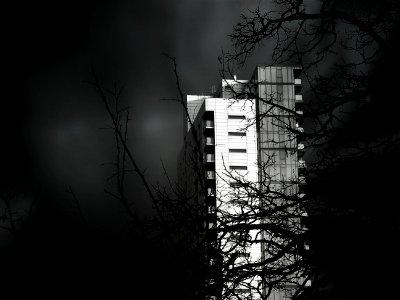 Grayscale Photo Of Concrete High Rise Building photo