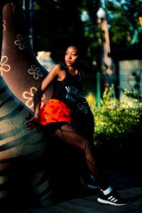 Woman Wearing Black Tank Top Near Brown Statue