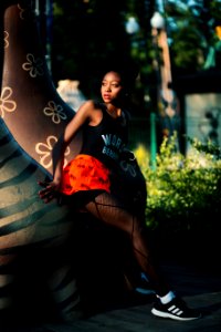 Woman Wearing Black Tank Top Near Brown Statue photo