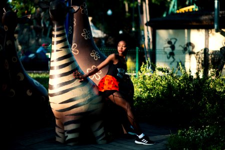 Photo Of Woman Beside Zebra Statue