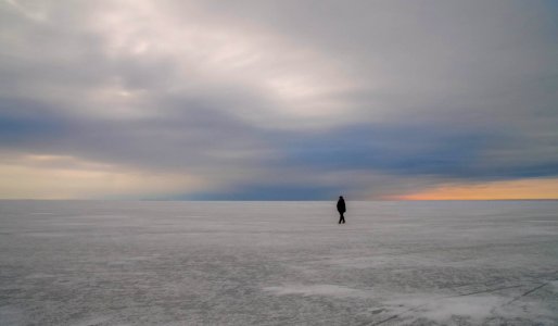 Silhouette Of Person Walking On Vast Land photo