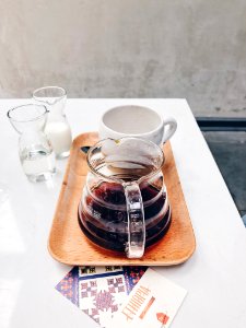 Clear Glass Coffee Pot Near White Mug On Brown Tray photo