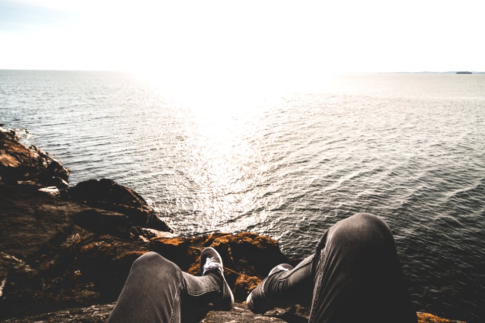 Photo Of Person Sitting On Cliff
