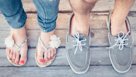 Closeup Photo Of Person Wearing Gray Boat Shoes And Gray Flip-flops photo