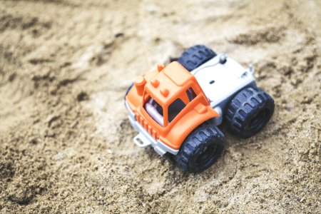 Orange And Gray Plastic Truck Toy On Sand photo