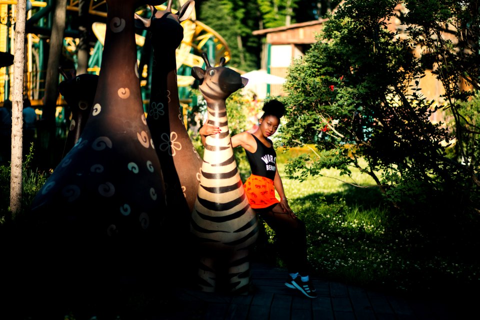 Photo Of Woman Sitting On Zebra Statue