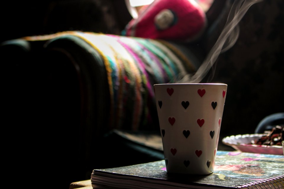 White Ceramic Cup On Book
