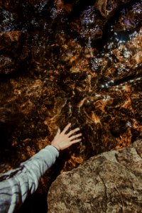 Person Touching Brown Stone photo