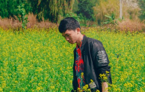 Man Wearing Black Jacket On Yellow Flowers