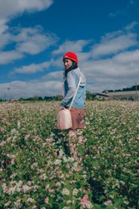 Woman Wearing Red Knit Hat And Blue Hoodie Jacket photo