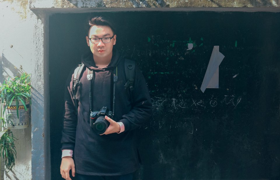 Man In Black Pullover Hoodie Holding Black Dslr Camera
